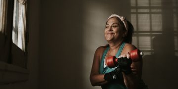 Mulher de meia-idade a fazer exercício de força com halteres